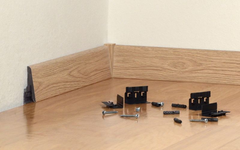 Sockelleisten-Zubehör für einfache Montage: abgebildet sind praktische Befestigungsclips, Schrauben und Dübel – die ideale Lösung, um Sockelleisten sauber, stabil und unsichtbar zu montieren. 